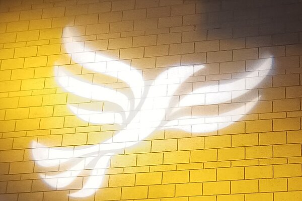 Lib Dem logo bird projected on blockwork