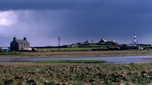 Garso, North Ronaldsay The house and loch at Garso, with the lighthouse in the distance.
