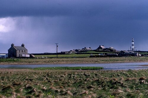 Garso, North Ronaldsay The house and loch at Garso, with the lighthouse in the distance.