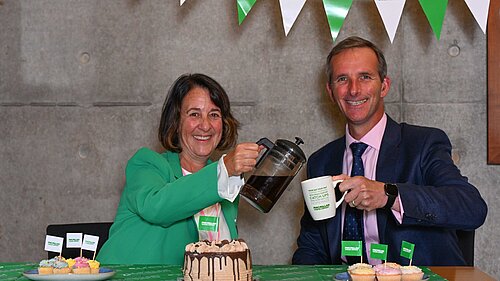 Woman pours cup of coffee