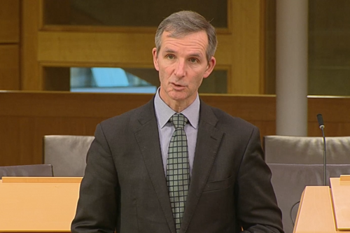 McArthur speaking in chamber